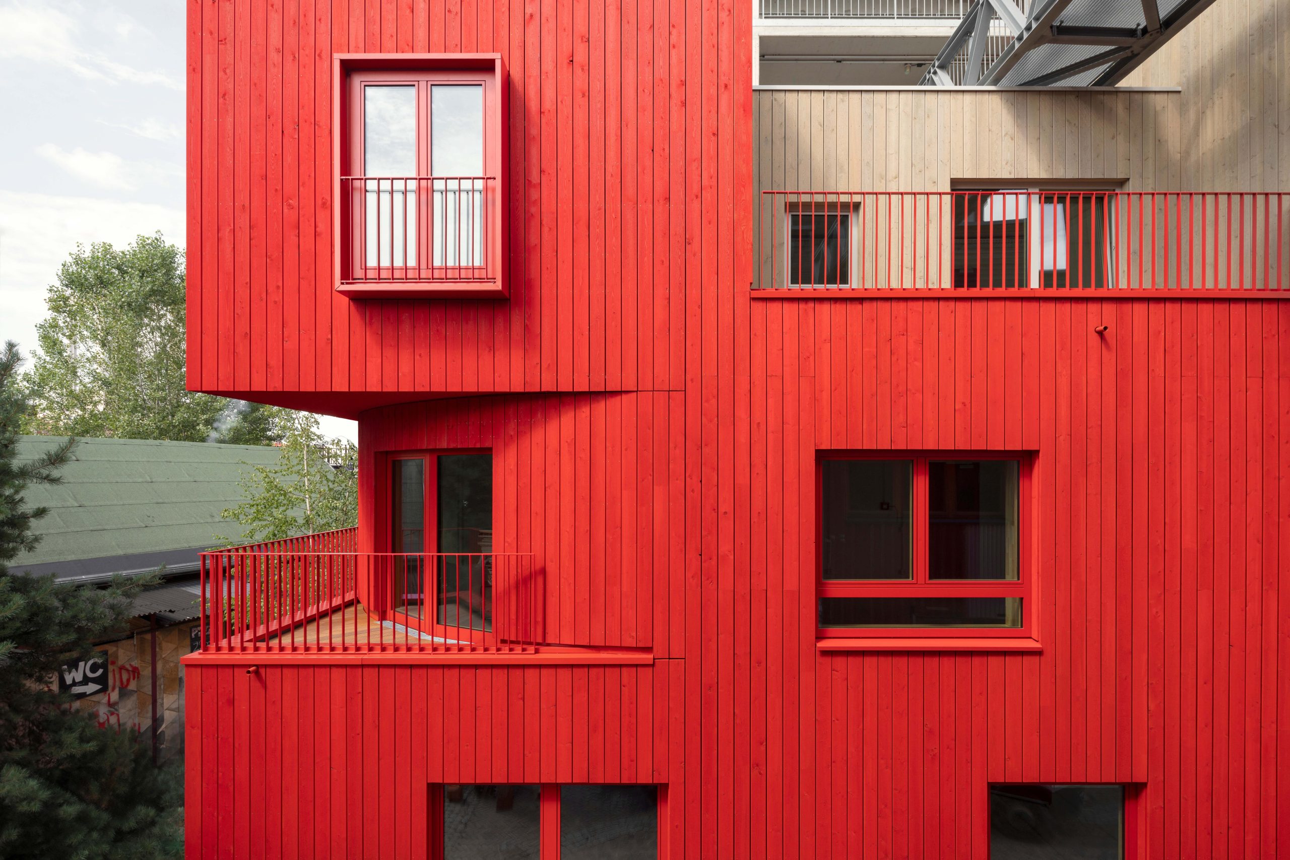 Red and larch wood exterior facade.