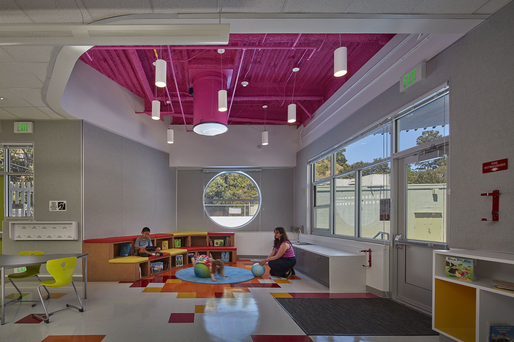 Classroom with pink exposed ceiling.